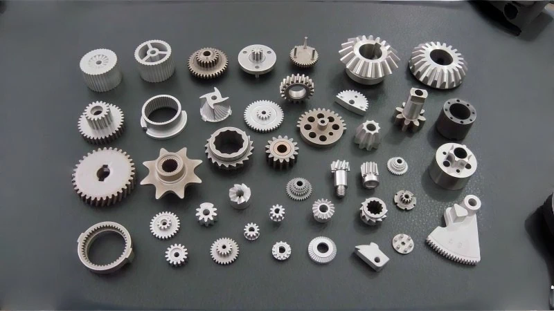 assortment of sintered metal gears and powder metallurgy parts posing machining challenges