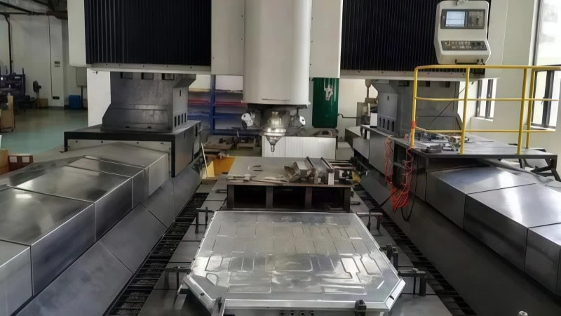 large cnc gantry milling machine processing an aluminum battery tray