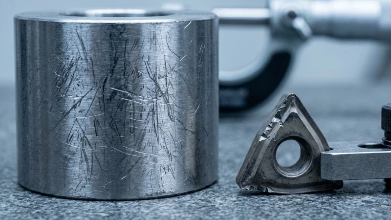 rough machined metal surface and damaged insert